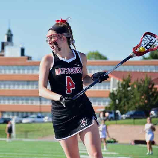 Lady Ravens lacrosse player looking to make a pass
